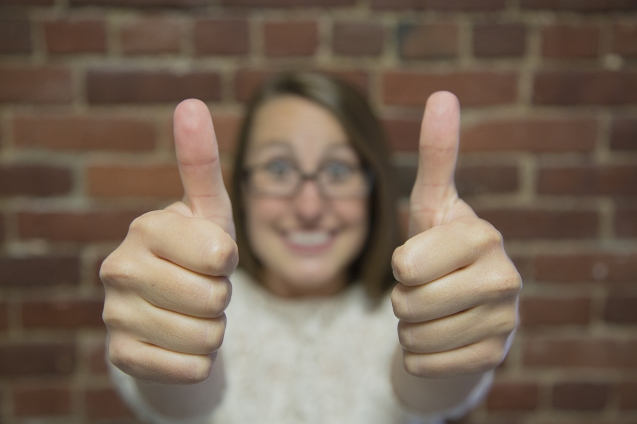 two thumbs up woman glasses positive attitude interview